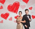 Happy young couple in elegant tuxedo and dress laughing