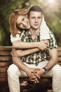 Happy young couple embrace and smiling sitting in the park. Royalty Free Stock Photo