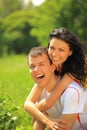 happy young couple enjoying backriding outdoors