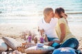 Happy young couple enjoying picnic on the beach and have good ti Royalty Free Stock Photo