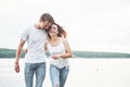 Happy young couple enjoying a solitary beach backriding