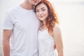 Happy young couple enjoying a solitary beach backriding