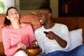 Happy young couple enjoying watching movie at home Royalty Free Stock Photo