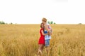 Happy young couple enjoying in the wheat field, summer season. Sunset light, flare light, copy space Royalty Free Stock Photo