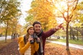 Happy young couple exploring in autumn at the park