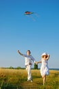 Happy young couple flying a kite