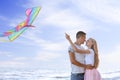 Happy young couple flying kite near sea Royalty Free Stock Photo