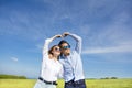 Happy young couple forming love shape Royalty Free Stock Photo