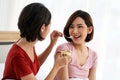 Happy young couple friend beautiful asia women enjoying cake together on the bed in bedroom Royalty Free Stock Photo
