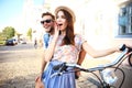 Happy young couple going for a bike ride on a summer day in the city.They are having fun together. Royalty Free Stock Photo