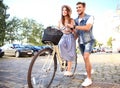 Happy young couple going for a bike ride on a summer day in the city.They are having fun together. Royalty Free Stock Photo