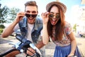 Happy young couple going for a bike ride on a summer day in the city.They are having fun together. Royalty Free Stock Photo