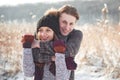 Happy young couple has fun on fresh snow at beautiful winter sunny day on vacation Royalty Free Stock Photo