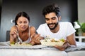 Happy young couple have breakfast at the bed. Care and romance at the morning. Royalty Free Stock Photo