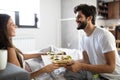 Happy young couple have breakfast at the bed. Care and romance at the morning. Royalty Free Stock Photo