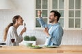 Happy young couple have fun cooking at home together