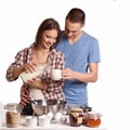 Happy young couple have fun in modern wooden kitchen indoor while preparing fresh food Royalty Free Stock Photo