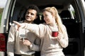 Happy young couple having a coffee break during a road trip in the countryside Royalty Free Stock Photo