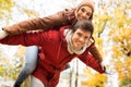 Happy young couple having fun in autumn park Royalty Free Stock Photo