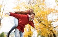 Happy young couple having fun in autumn park Royalty Free Stock Photo