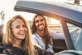 Happy young couple having fun inside convertible sport car - Travel people doing road trip in tropical place - Vacation, journey Royalty Free Stock Photo