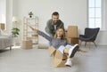 Happy young couple having fun in the living room of their new house on moving day Royalty Free Stock Photo
