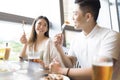 Happy young couple having fun during lunch in restaurant Royalty Free Stock Photo