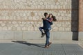 Happy young couple having fun outdoors on a sunny day. Urban, architecture. Fun and lifestyle Royalty Free Stock Photo