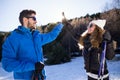 Happy young couple having fun over winter background. Royalty Free Stock Photo