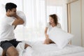 Happy young couple having fun with pillow fight on the bed in bedroom. Enjoying , Love, Relationship