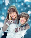 Happy young couple having fun playing outdoors in winter Royalty Free Stock Photo