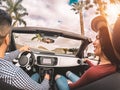 Happy young couple having fun during road trip in convertible car - Romantic lovers enjoying time together driving cabriolet auto Royalty Free Stock Photo