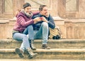 Happy young couple having fun with smartphone outdoors Royalty Free Stock Photo