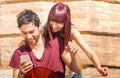 Happy young couple having fun with smartphone at urban location - Friendship love concept with hipster best friends on tech