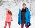 Happy young couple having fun together in snow in winter woodland Royalty Free Stock Photo