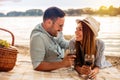 Happy young couple having a picnic at the beach Royalty Free Stock Photo