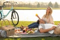 Happy young couple having picnic near lake Royalty Free Stock Photo