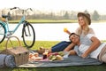 Happy young couple having picnic near lake Royalty Free Stock Photo