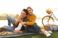 Happy young couple having picnic near lake Royalty Free Stock Photo