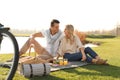 Happy young couple having picnic near lake Royalty Free Stock Photo