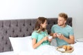 Happy young couple having romantic breakfast in bed Royalty Free Stock Photo