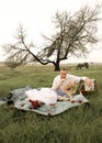 Happy young couple having a romantic picnic outdoors in green field Royalty Free Stock Photo