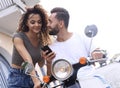 Happy young couple having summer trip on a scooter Royalty Free Stock Photo