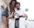 Happy young couple having summer trip on a scooter Royalty Free Stock Photo