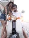 Happy young couple having summer trip on a scooter Royalty Free Stock Photo