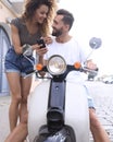 Happy young couple having summer trip on a scooter Royalty Free Stock Photo