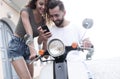 Happy young couple having summer trip on a scooter Royalty Free Stock Photo