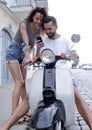 Happy young couple having summer trip on a scooter Royalty Free Stock Photo