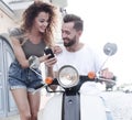 Happy young couple having summer trip on a scooter Royalty Free Stock Photo