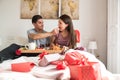 Happy young couple having a surprising breakfast on bed Royalty Free Stock Photo